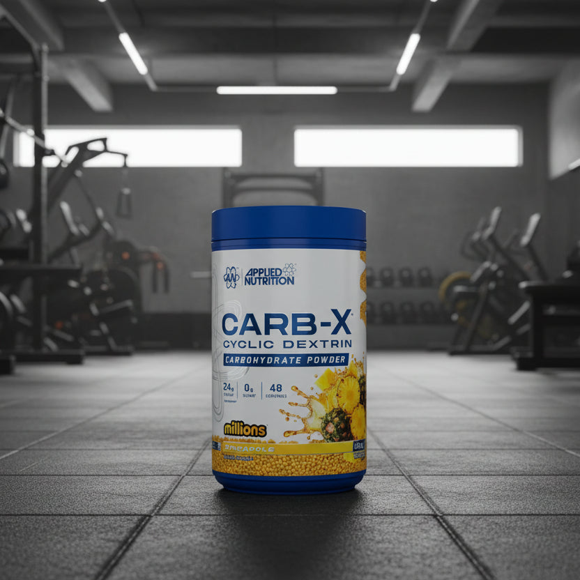 Applied Nutrition Carb-X Cyclic Dextrin powder container on a gym floor