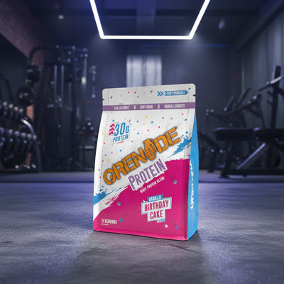 Grenade Protein package with birthday cake flavor in a gym setting