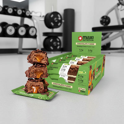 Maxi Nutrition Chocolate Fudge protein bars with packaging in a gym setting