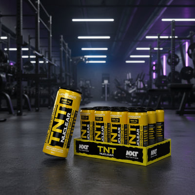 Yellow and black pre-workout supplement cans with packaging on a gym background