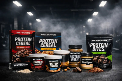 NULTRAFITUK functional nutrition products including protein cereal, protein porridge, protein spreads and snacks displayed on a gym floor with dark lighting and misty atmosphere.