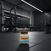 Jar of Grenade protein spread on a gym floor with equipment in the background