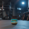 Jar of Grenade chocolate protein powder on a gym floor with equipment in the background