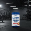 Applied Nutrition Carb-X Cyclic Dextrin powder container on a gym floor