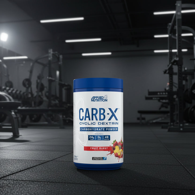 Applied Nutrition Carb-X Cyclic Dextrin powder container on a gym floor