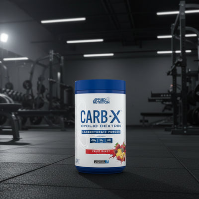 Applied Nutrition Carb-X Cyclic Dextrin powder container on a gym floor