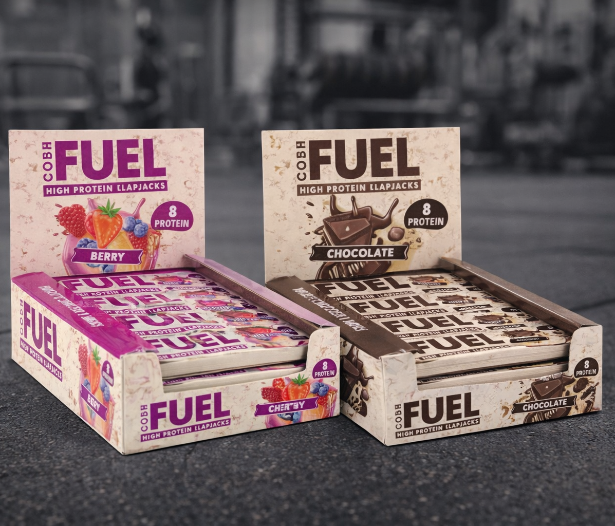 Boxes of Fuel high protein snack bars on a gym background
