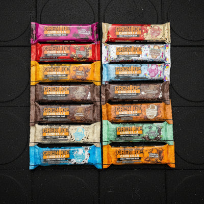 Assorted Grenade Carb Killa high protein bars in various flavours in a gym floor