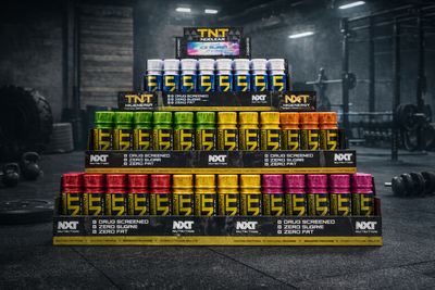 Stack of supplement bottles with visible branding in a gym setting