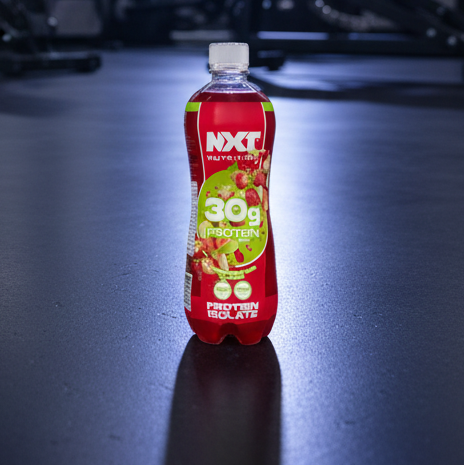 Red protein supplement bottle with green label on a dark surface