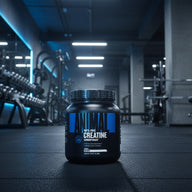 Black container of Animal 100% Pure Creatine Monohydrate on a gym background