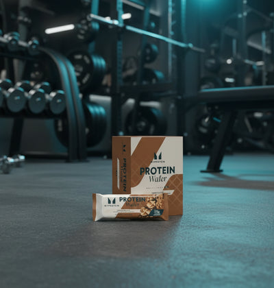 Protein wafer packaging on a gym floor with gym equipment in the background