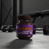 Jar of Grenade protein spread on a gym floor with weights in the background
