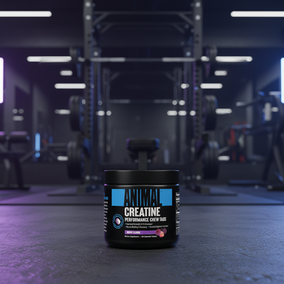 Container of Animal Creatine on a gym floor with equipment in the background