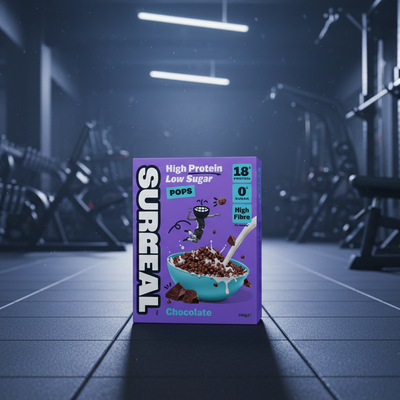 Purple cereal box with 'Surreal' branding in a gym setting