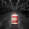 Supplement container labeled 'MASS' in a gym setting