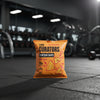 Orange package of 'The Curators Protein Chips' on a gym floor.