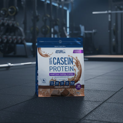 Package of Applied Nutrition 100% Casein Protein Powder in Chocolate Cream flavour on a gym background.